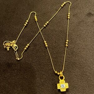 gold cross necklace with rhinestones on detailed chain